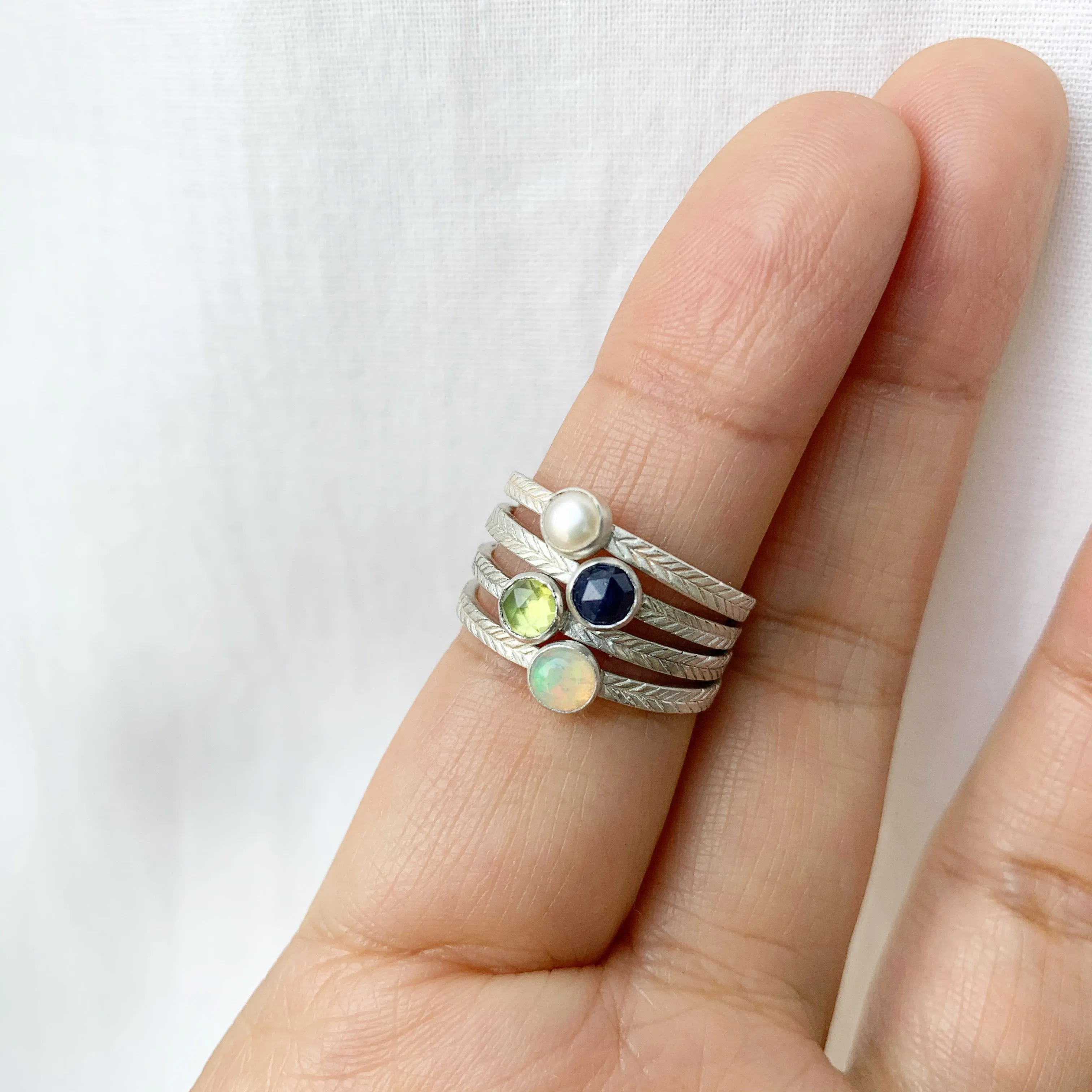 Pearl ring with hand-carved feather textures